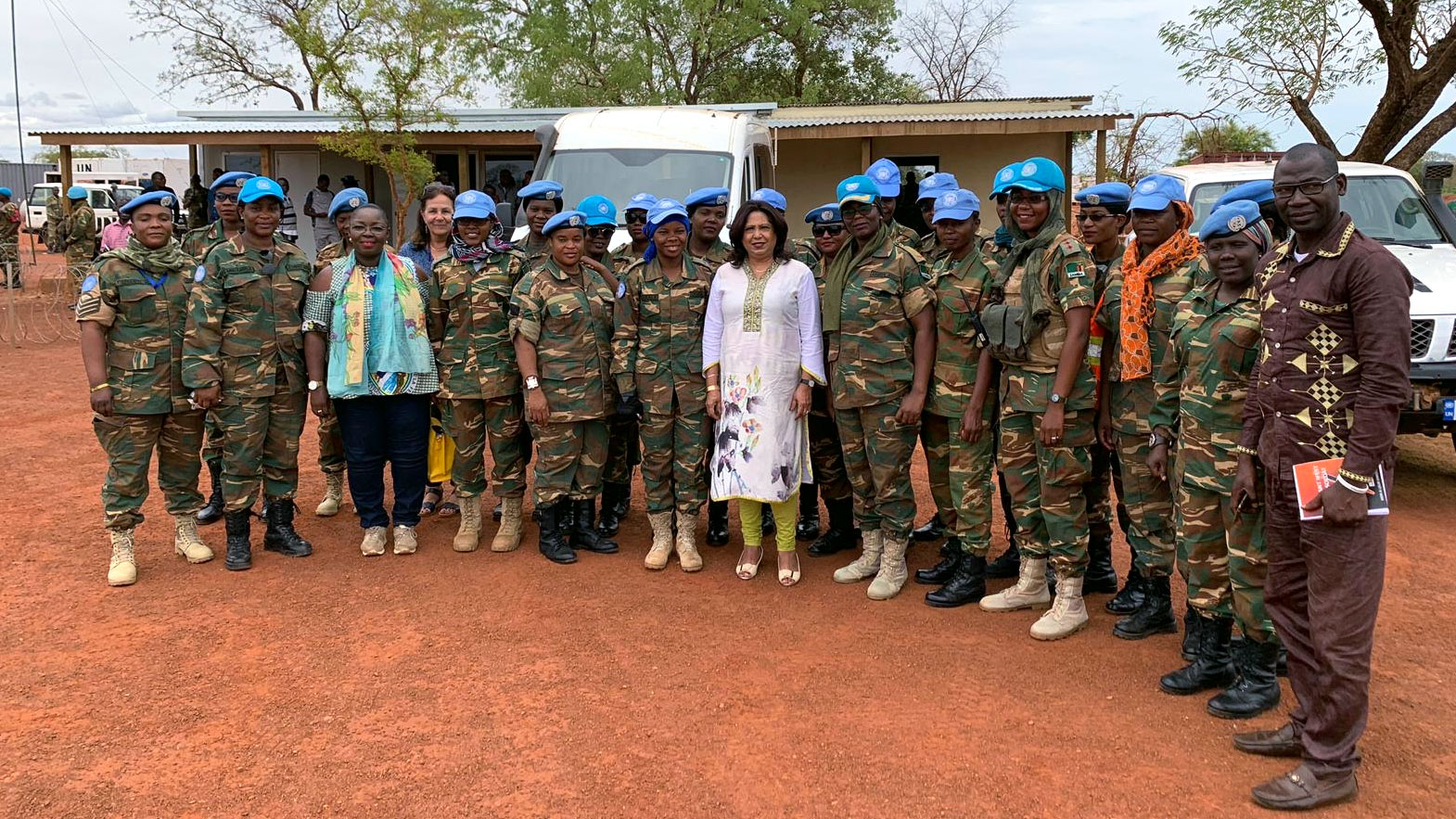 Pramila stands in a row of female peacekeeping officers in uniform.