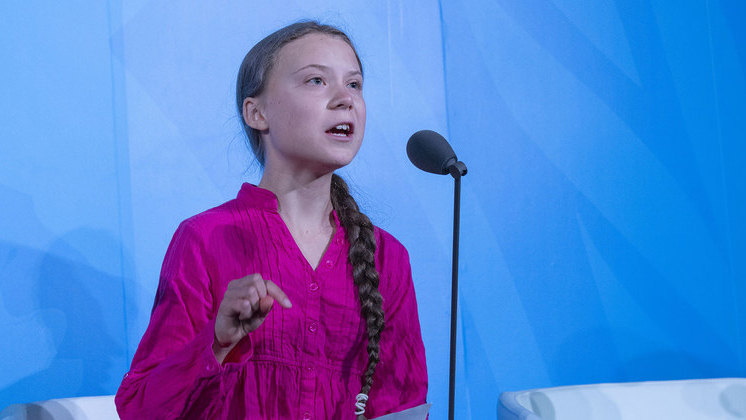 Greta Thunberg with a microphone