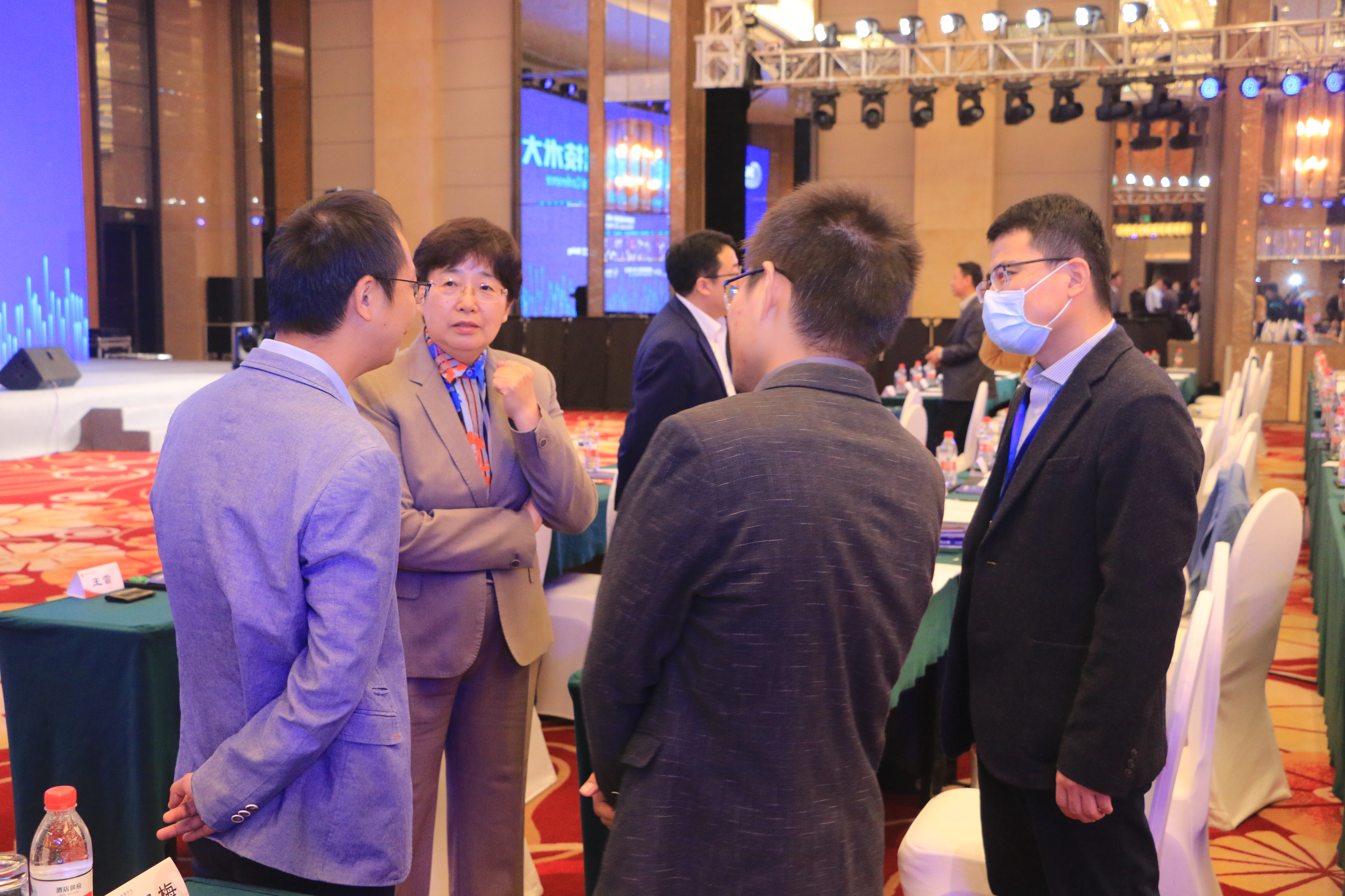 A group are in deep discussion in a conference hall.