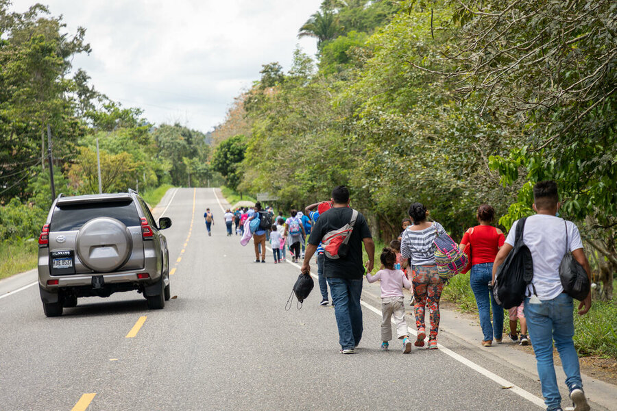 Backshot of people walking on a road for cars.
