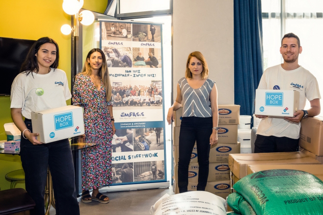 people holding boxes of food supplies