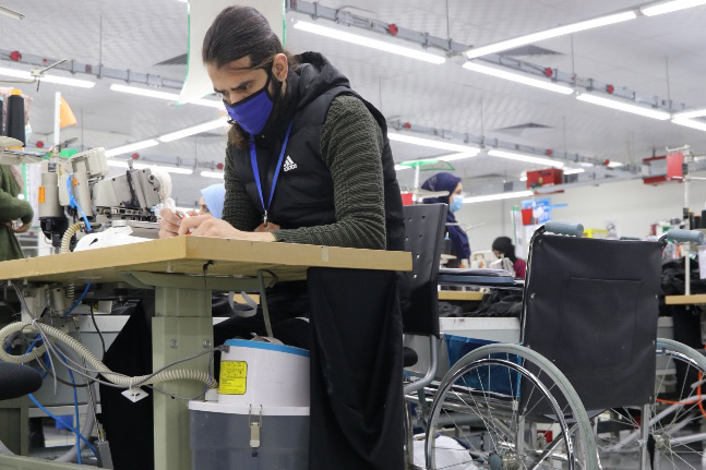 man with wheelchair at workstation