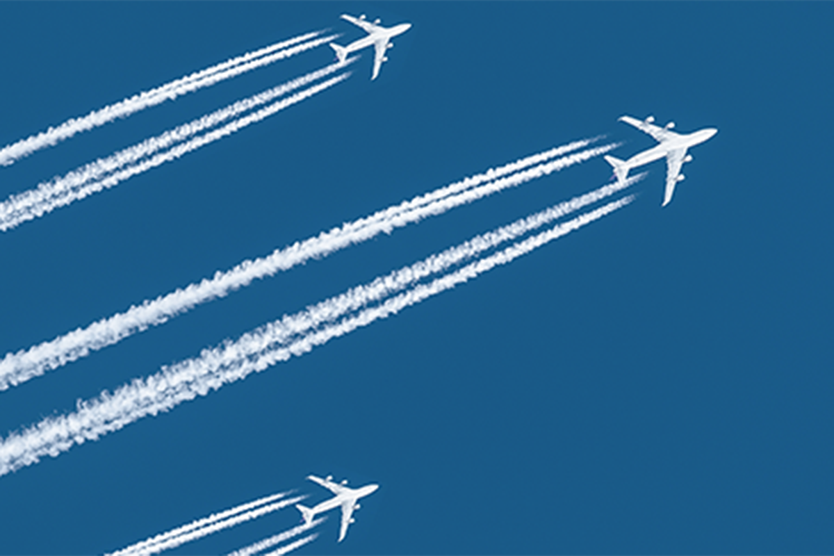 three planes flying with two sets of contrails each