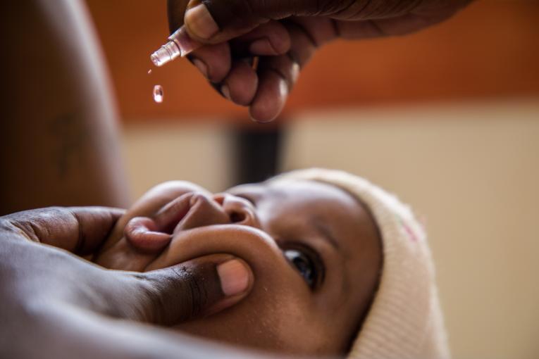 baby receiving oral vaccine