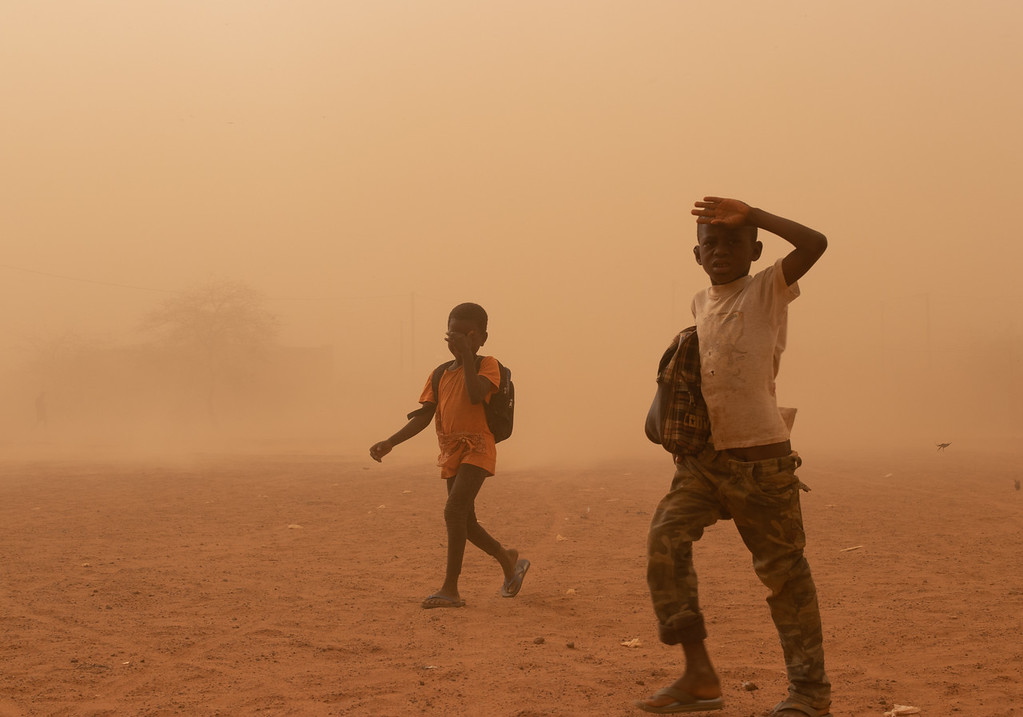 two children caught in a sand storm