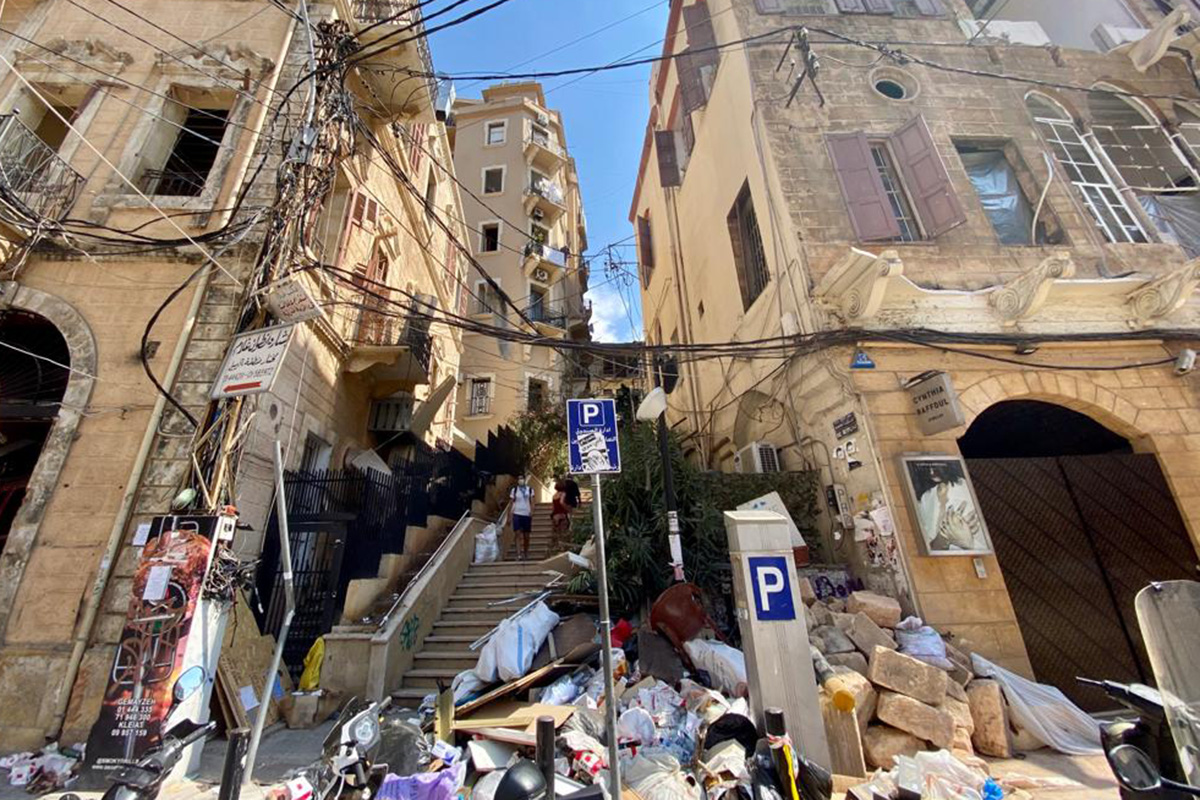 Rubble at the foot of stairs in between buildings.