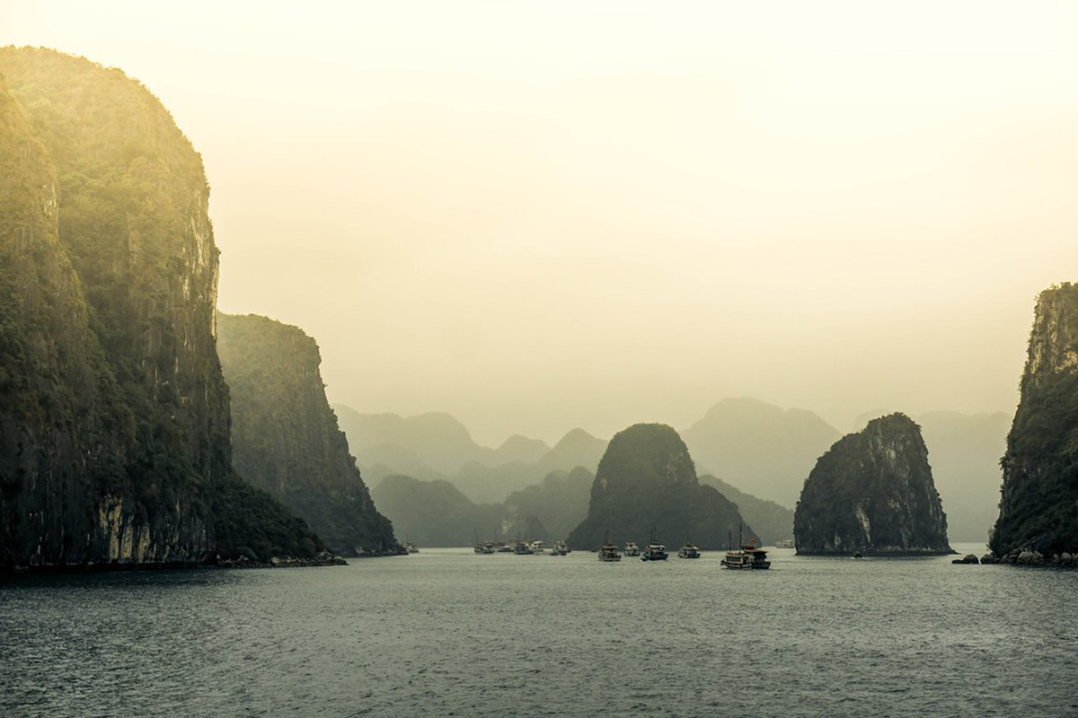 Boats at sea against the backdrop of Ha Long Bay’s limestone pillars