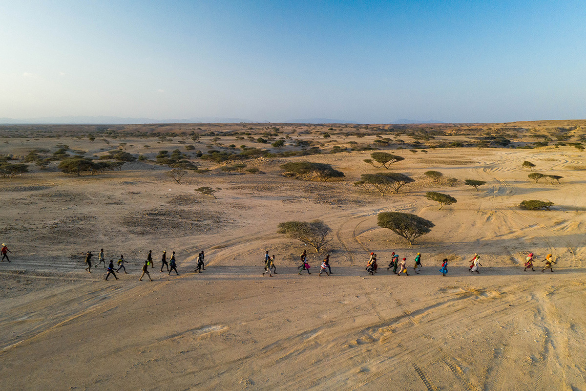 People crossing through a desert 