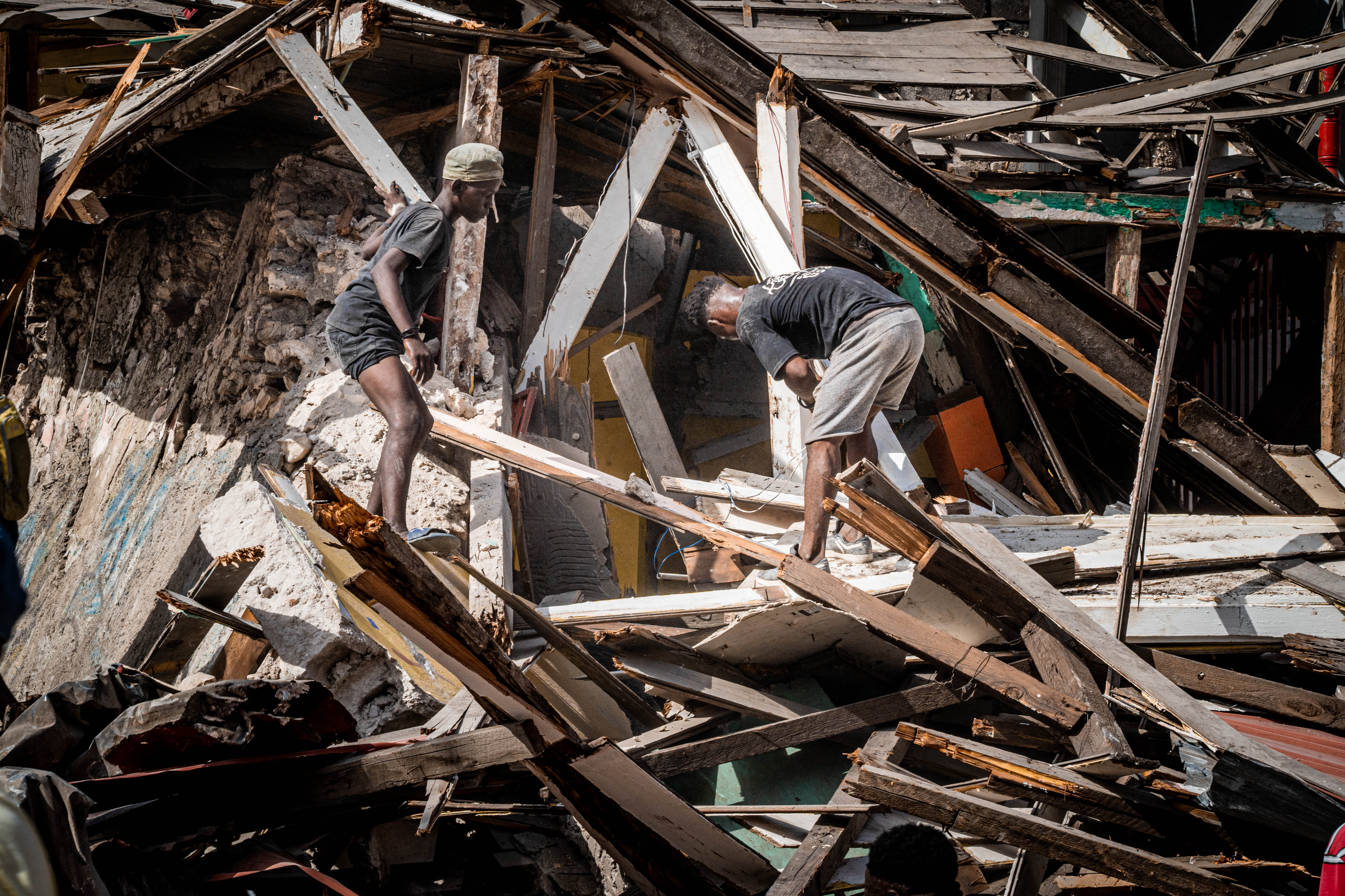 young men cleaning up wreckage