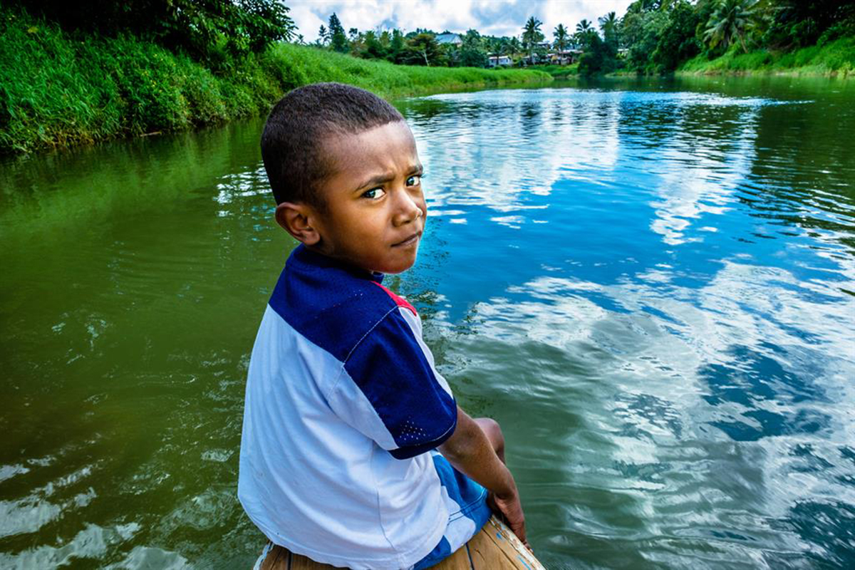 Portrait of a boy by a lake