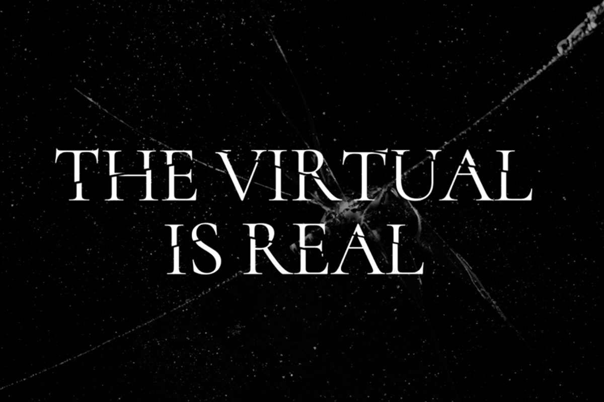 An image of shattered glass that reads “The Virtual is Real” 