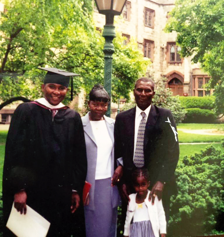 Selwin Hart posing for a picture with family at a University campus