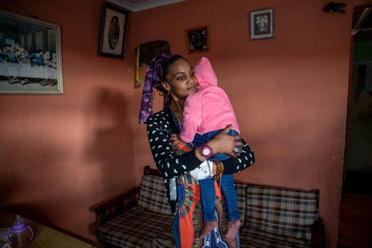 mother holding toddler