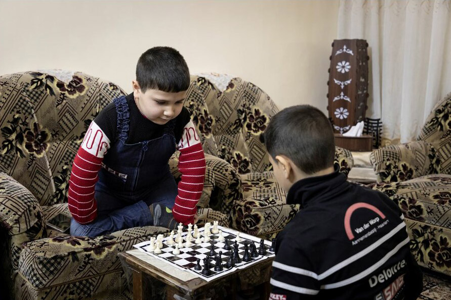 Youssef playing chess with a classmate