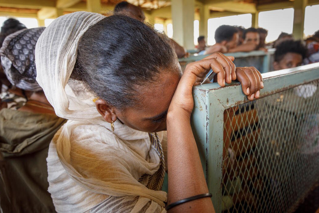 Eritrean refugees wait to receive humanitarian aid at Mai Aini refugee camp in Ethiopia’s Tigray region