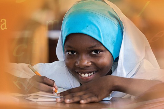 smiling girl writing in notebook