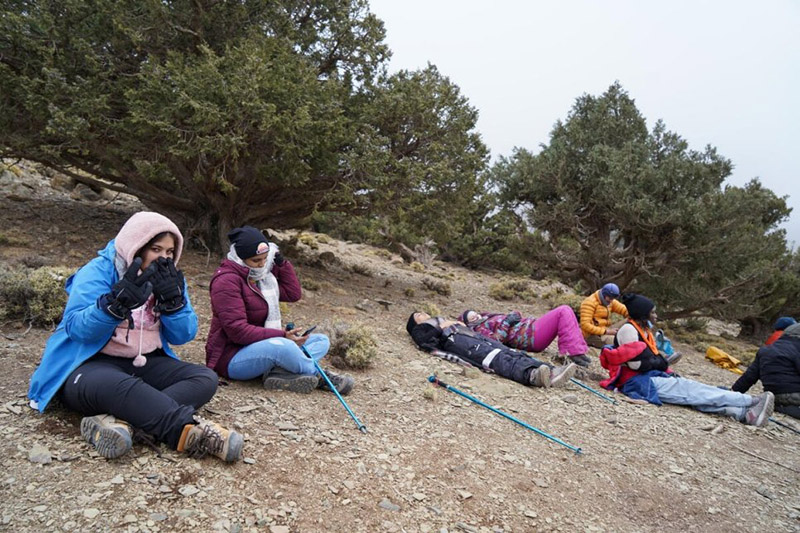 A group of refugee women living in Morocco take a break during their ascent of Mount Toubkal. 