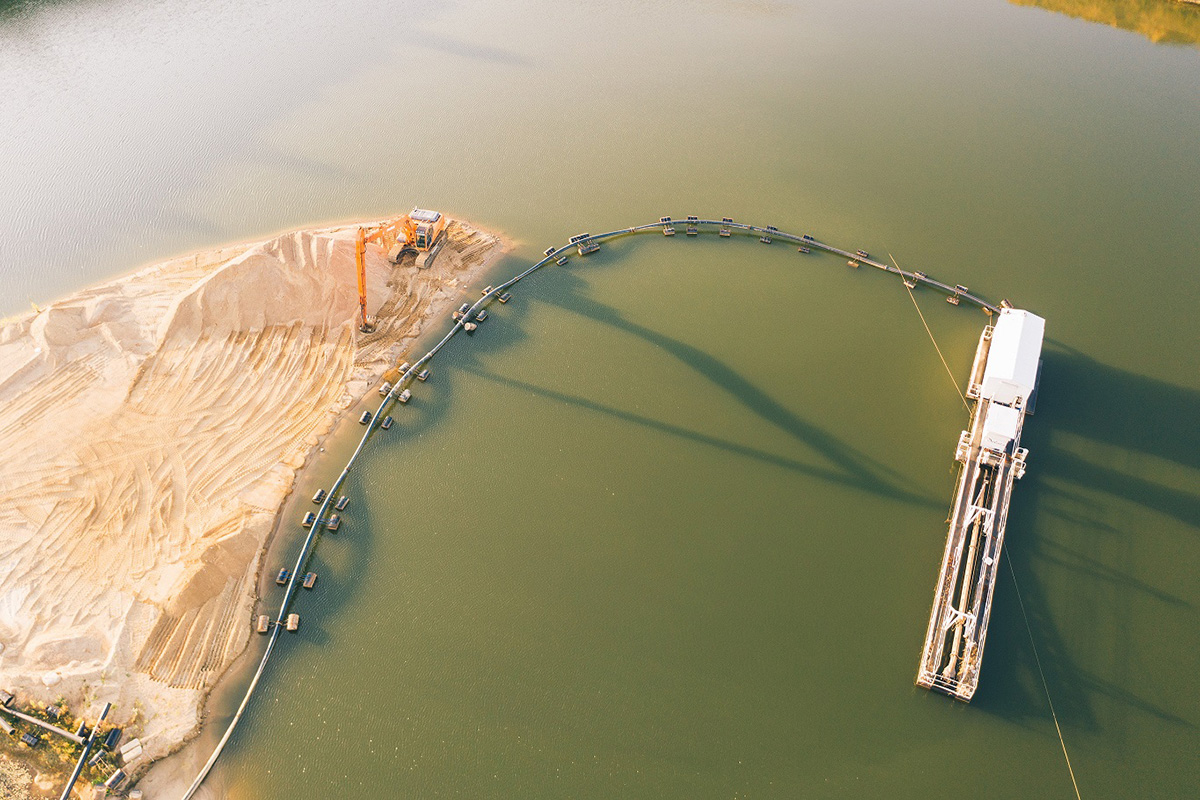 Aerial view of a sand extraction site near the water