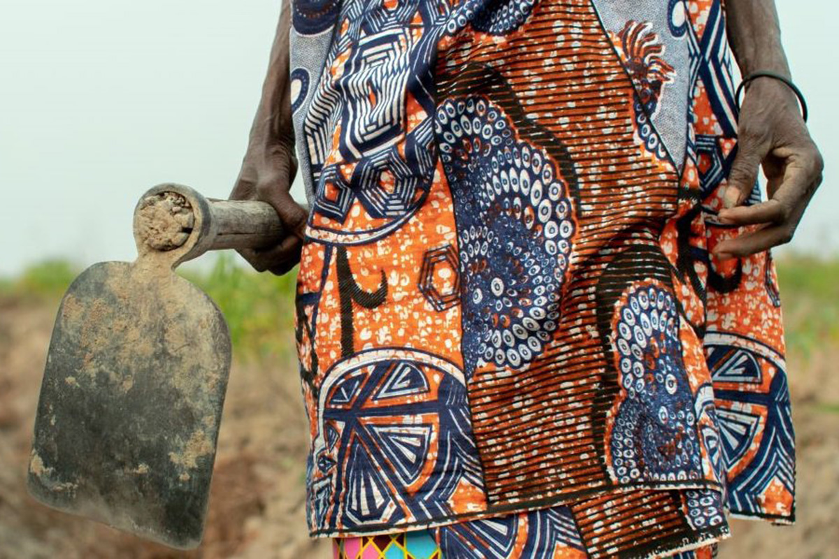 Close up of a hoe held by a woman