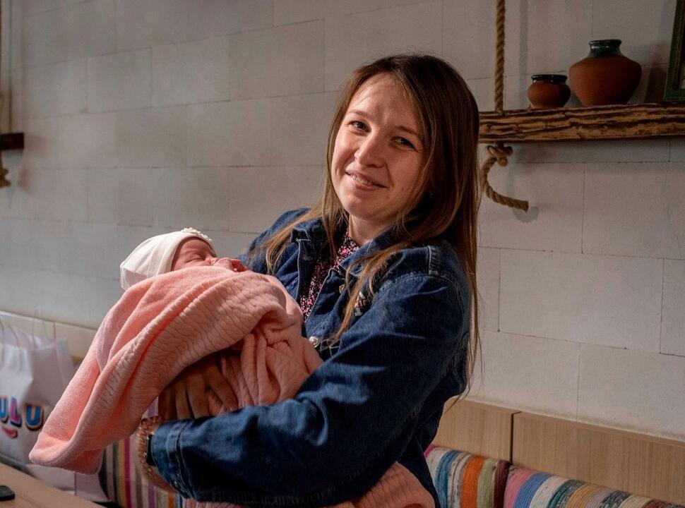 Olga holds her newborn