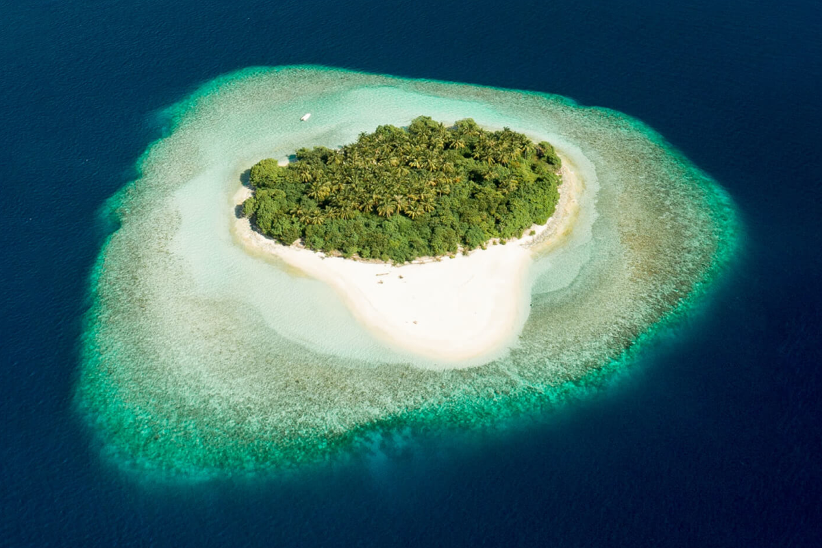 Aerial view of a small uninhabited island with beaches and vegetation