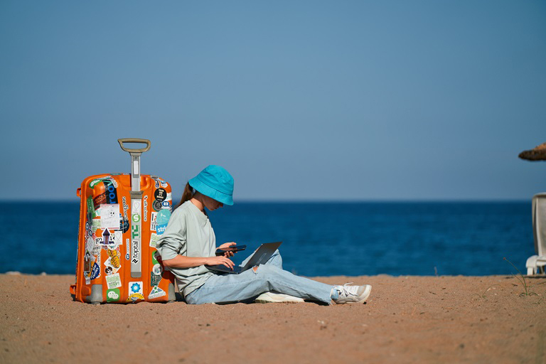 a girl at a beach looking at her phone