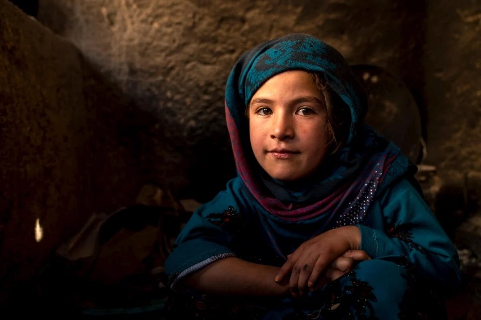 Young Afghan girl in blue headscarf.