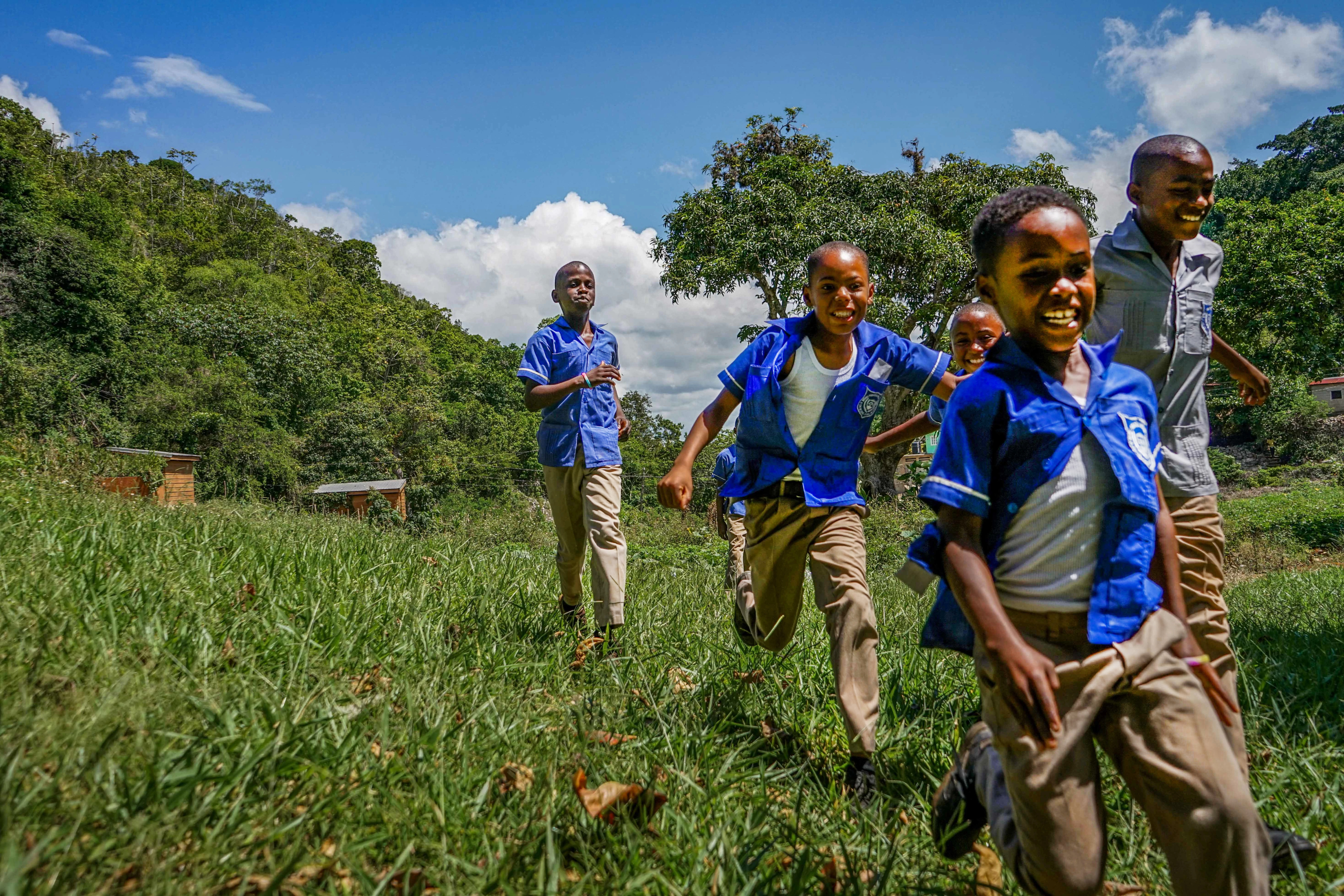 Children of African descent running in a field