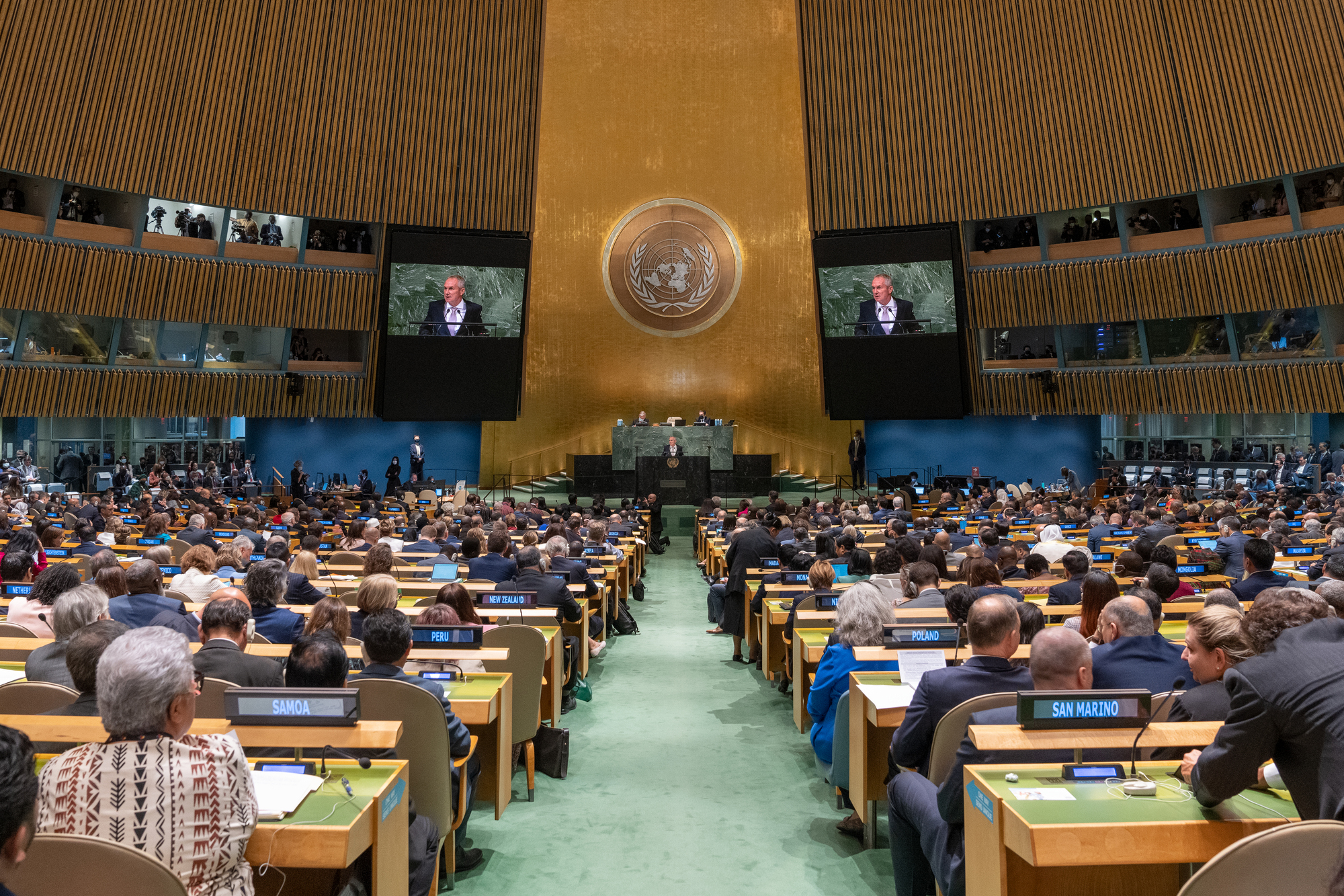 Csaba Kőrösi (at podium and on screens), President of the seventy-seventh session of the United Nations General Assembly