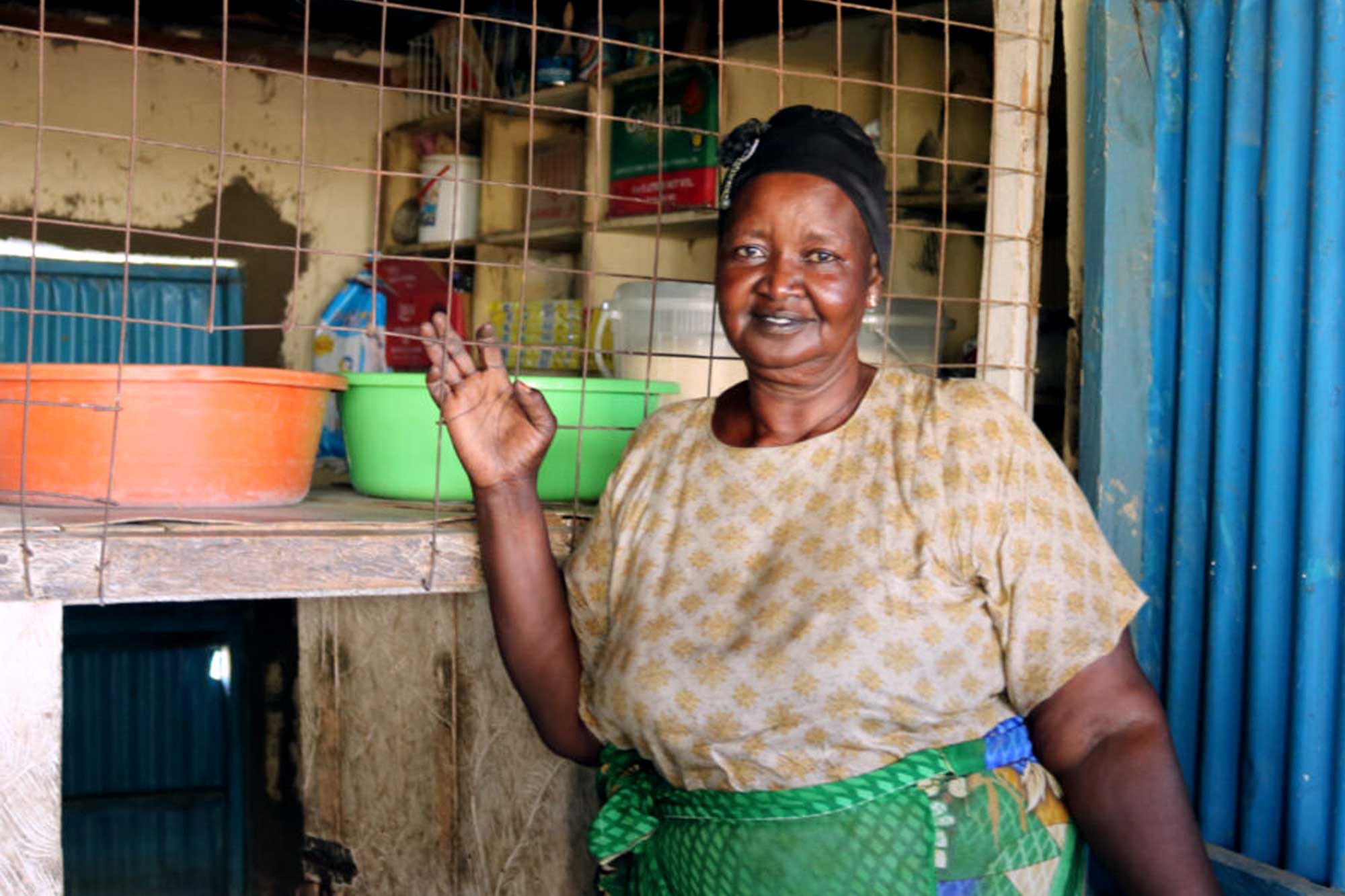 Suad stands next to her shop