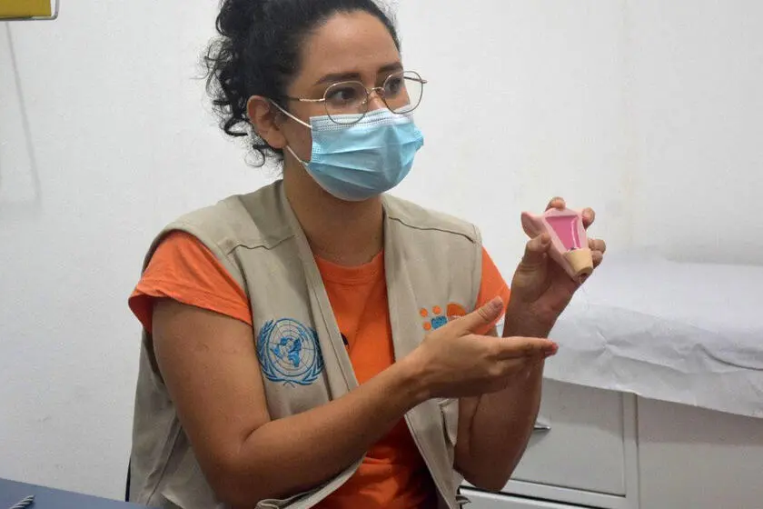 Nurse showing replica of uterus