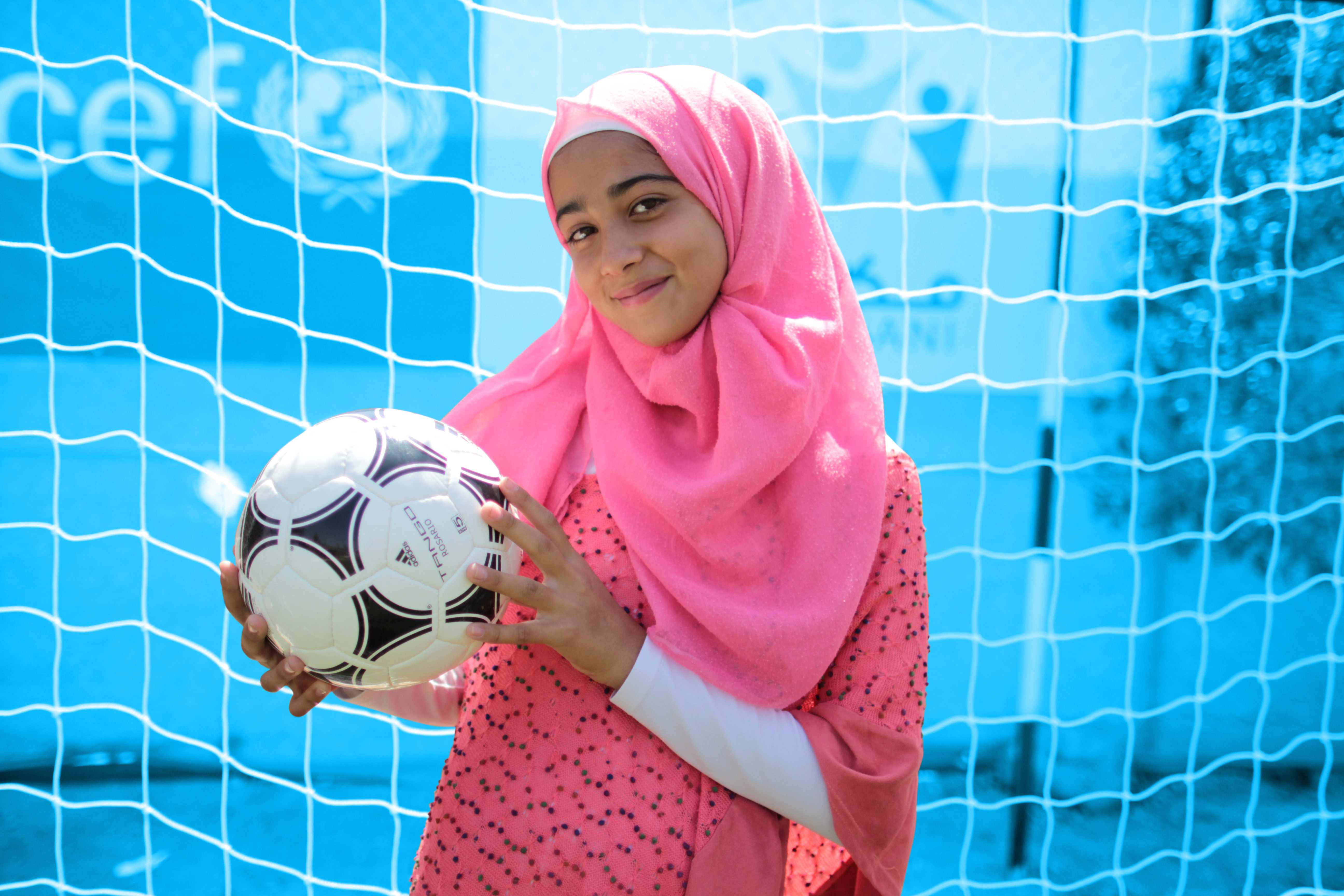 Girl holding a soccer ball