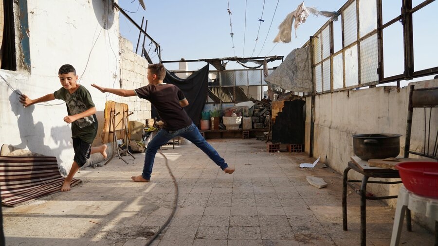 Two boys playing on terrace.