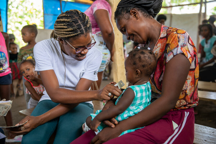 humanitarian worker with mother and baby