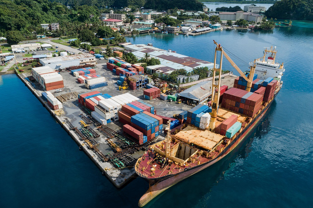 A container ship unloads cargo at a port in the Federated States of Micronesia.