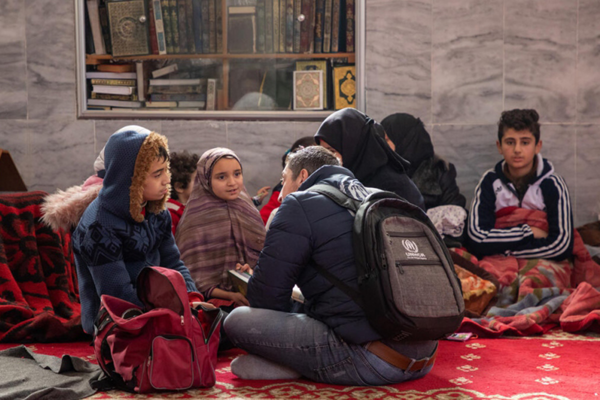 People sitting in a circle on a rug on the floor