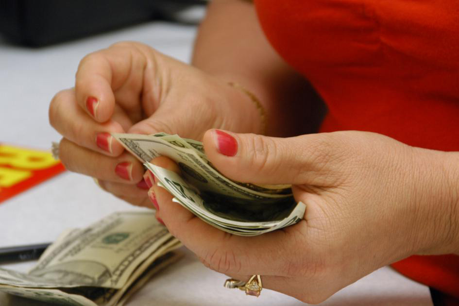 hands of woman counting bills