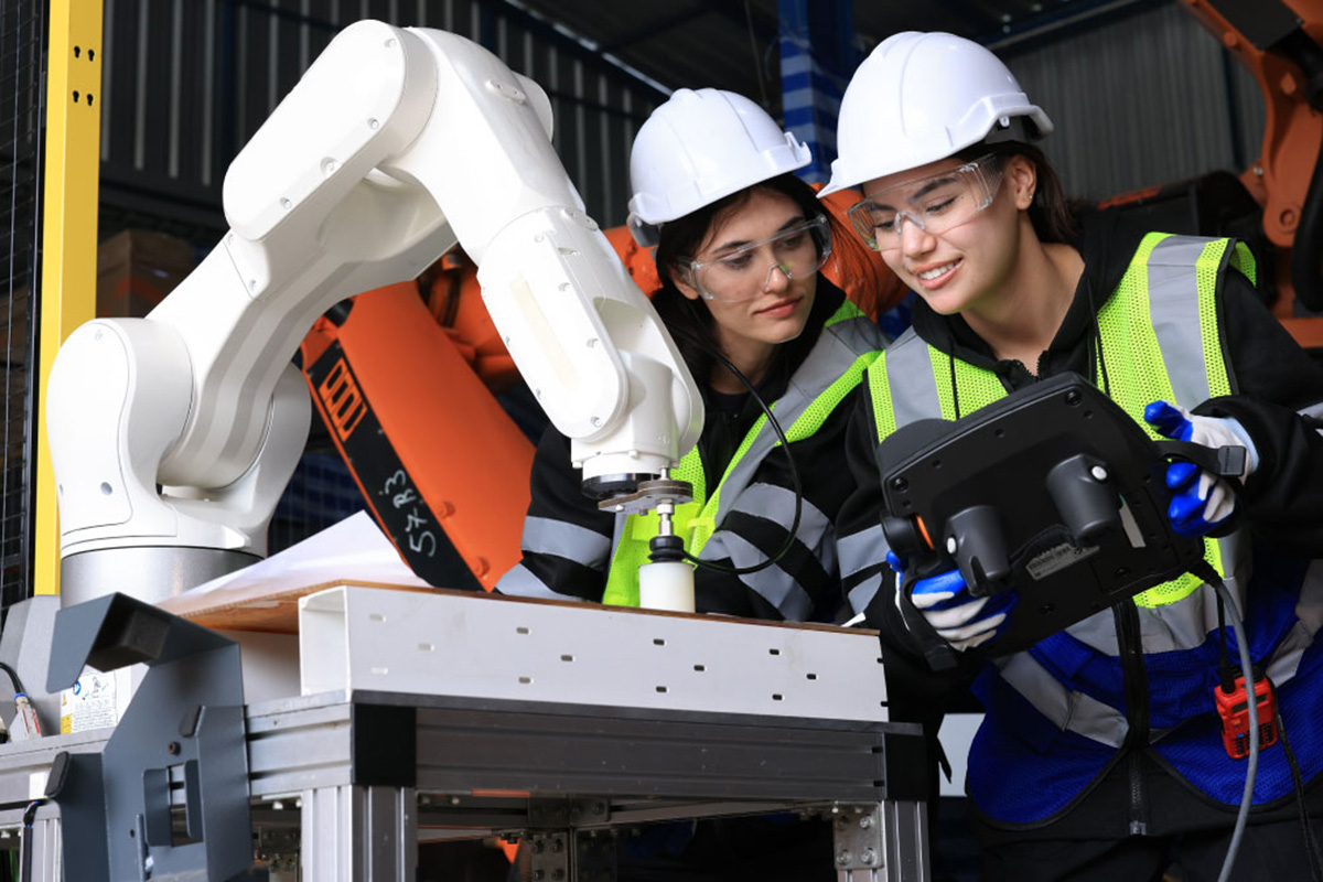 Two women engineers testing an AI device.