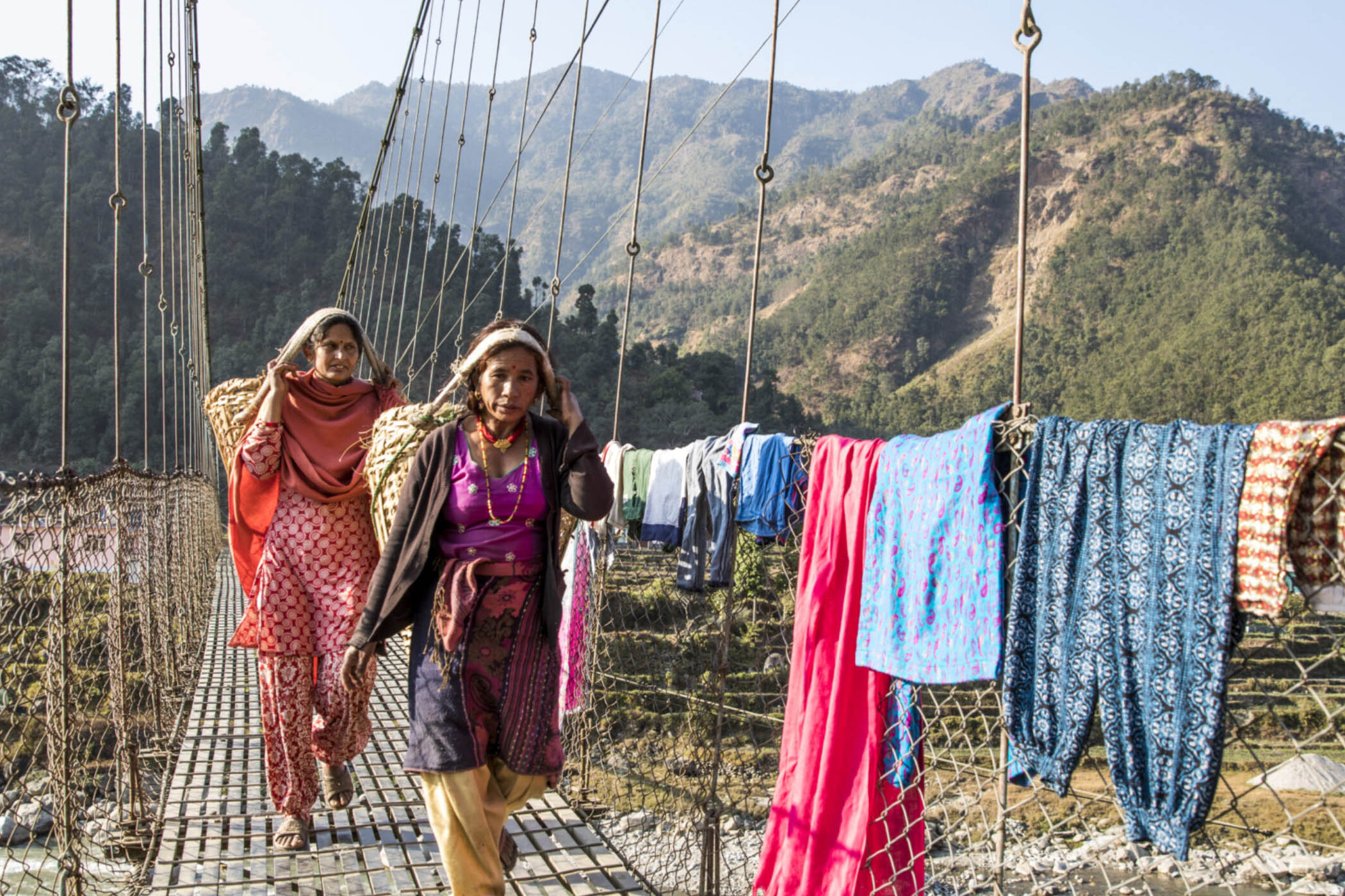 women walking on rope bridge