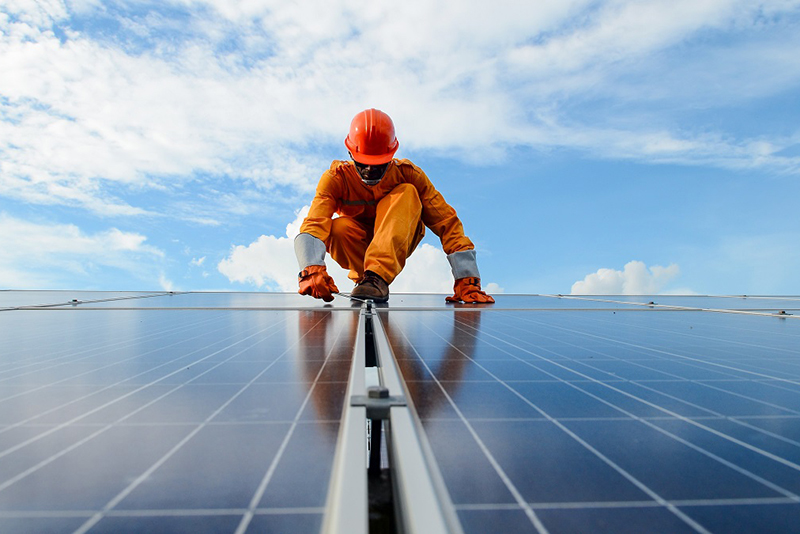 man working on solar panels