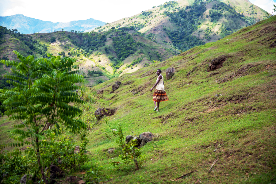 woman walking in hills, looking back