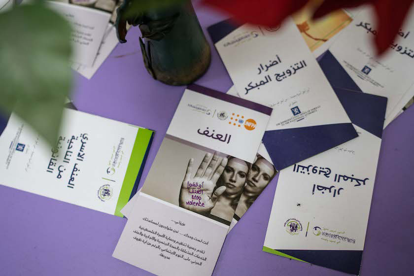 Brochures spread on a table seen from above. 