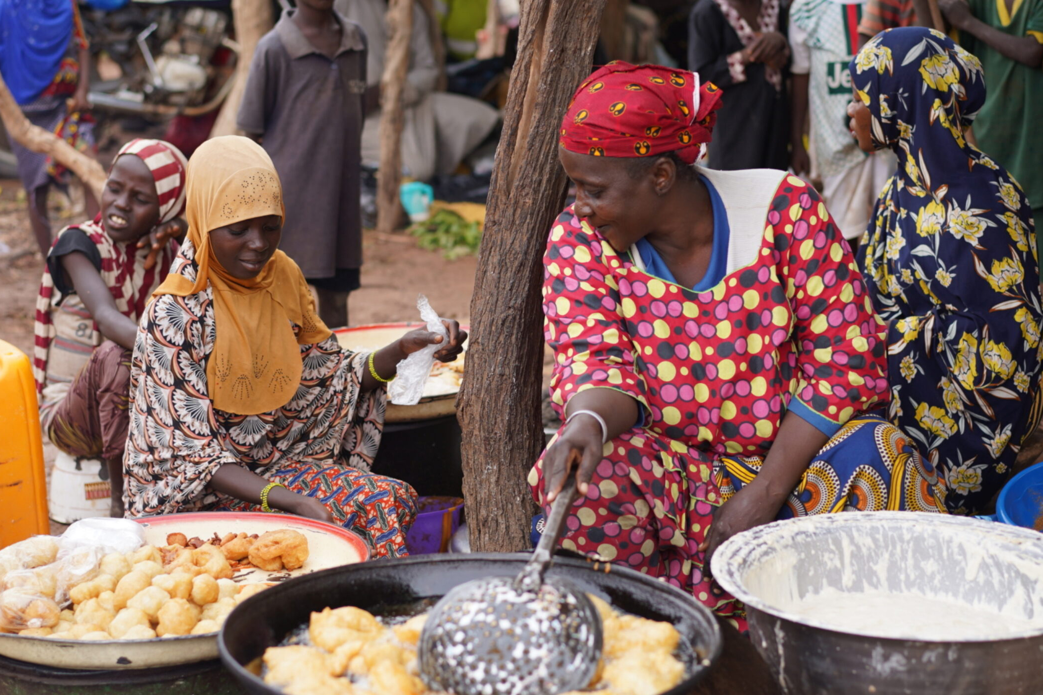 woman selling prepared food at a market in Niger