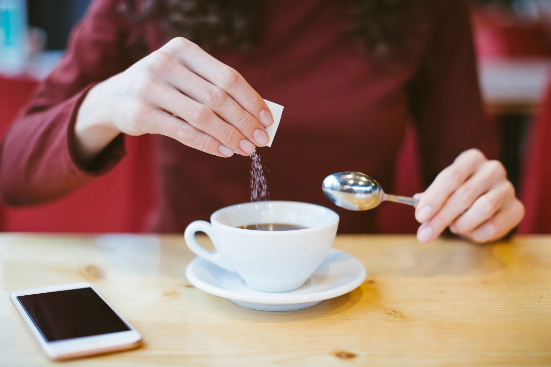 Female hands with coffee and sugar.