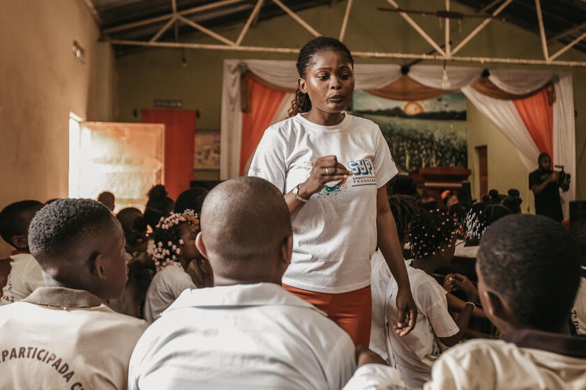 A woman in front of a group of young people