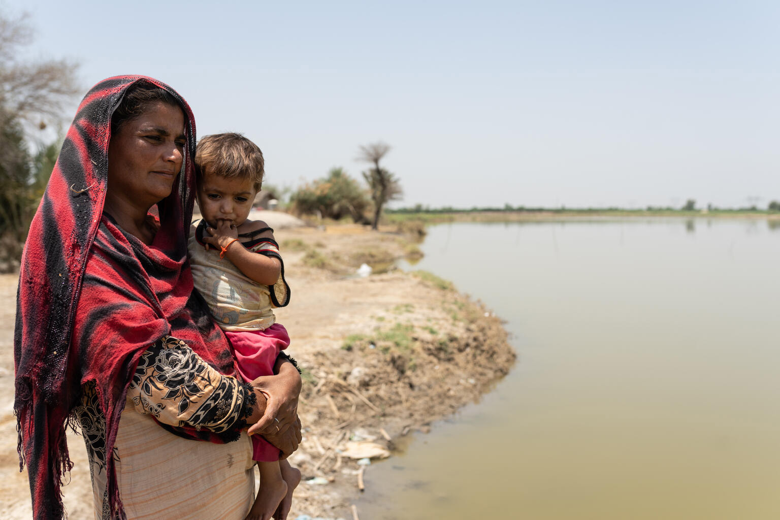 Woman holding a child looking into the distance