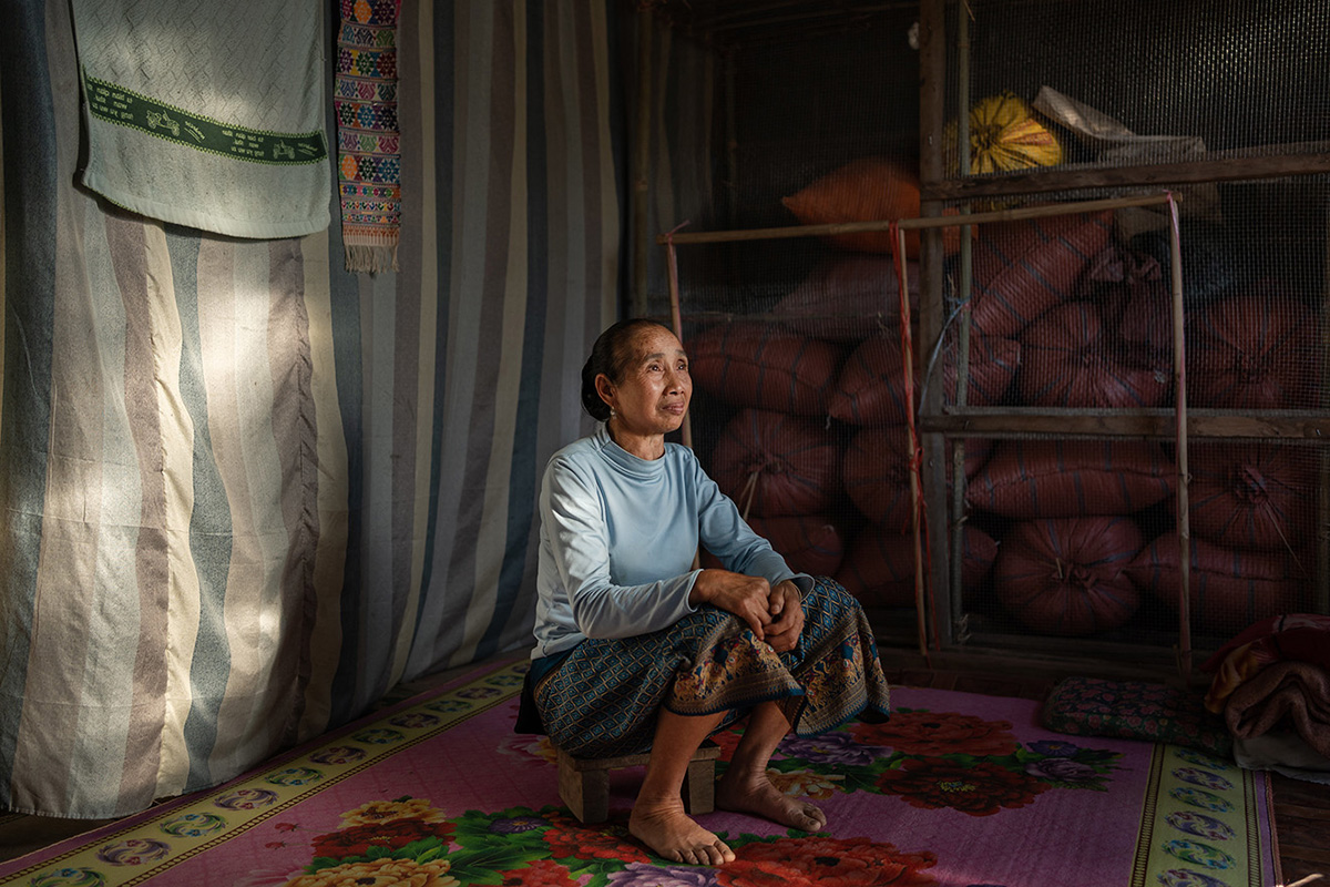 a woman poses for a portrait at her home