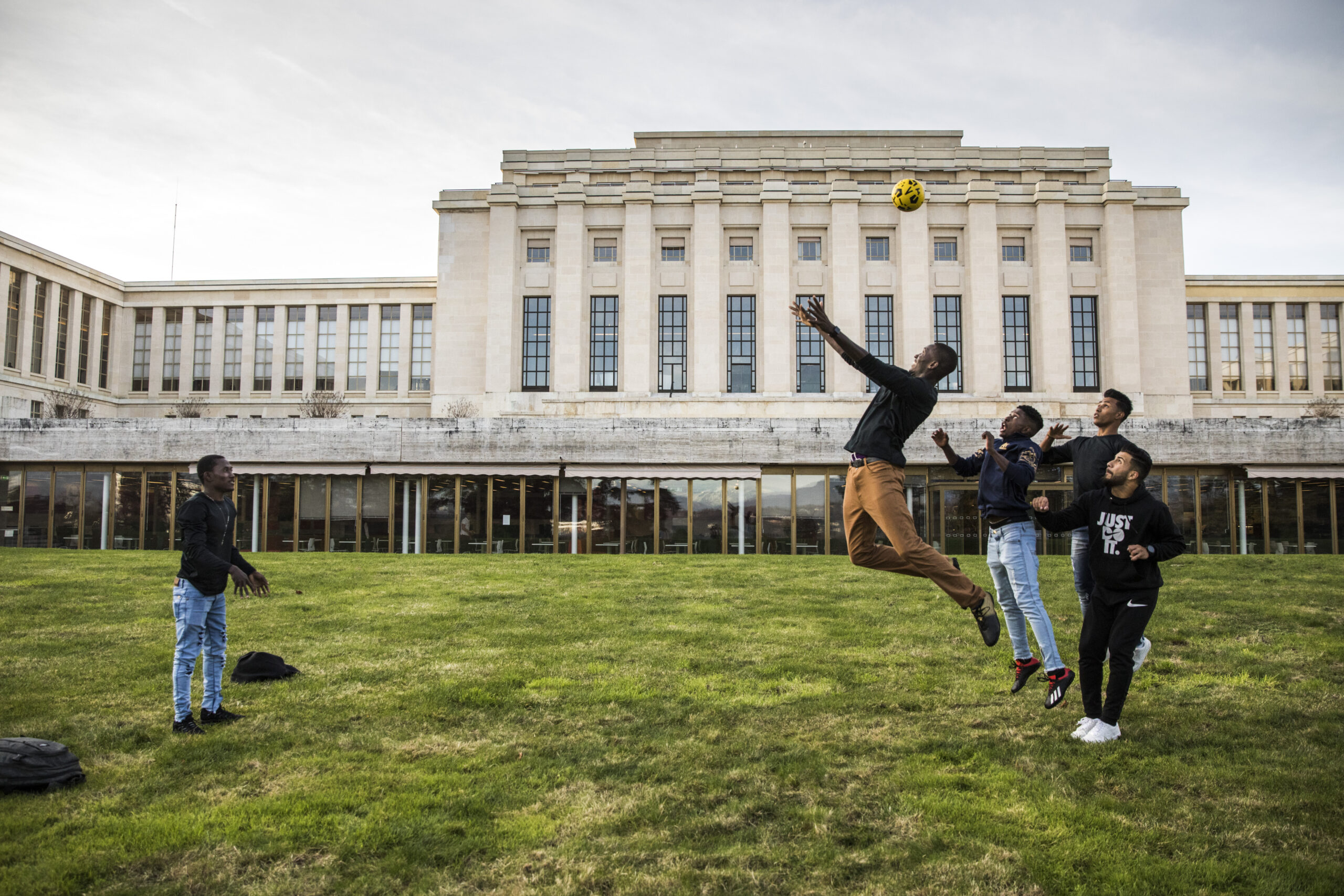 a group of men prepare to head the ball in the air