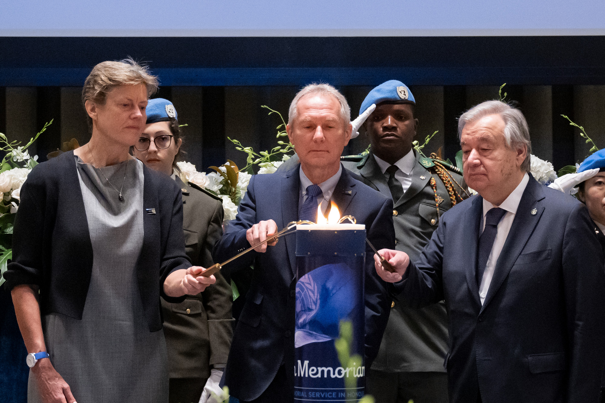 Three UN Officials light a candle