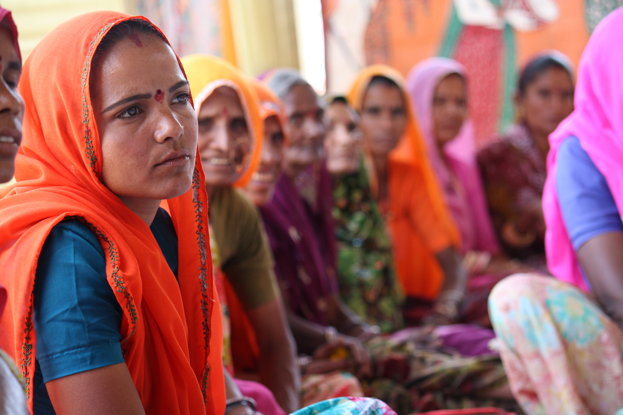 A village council head attends a meeting to develop her leadership skills.